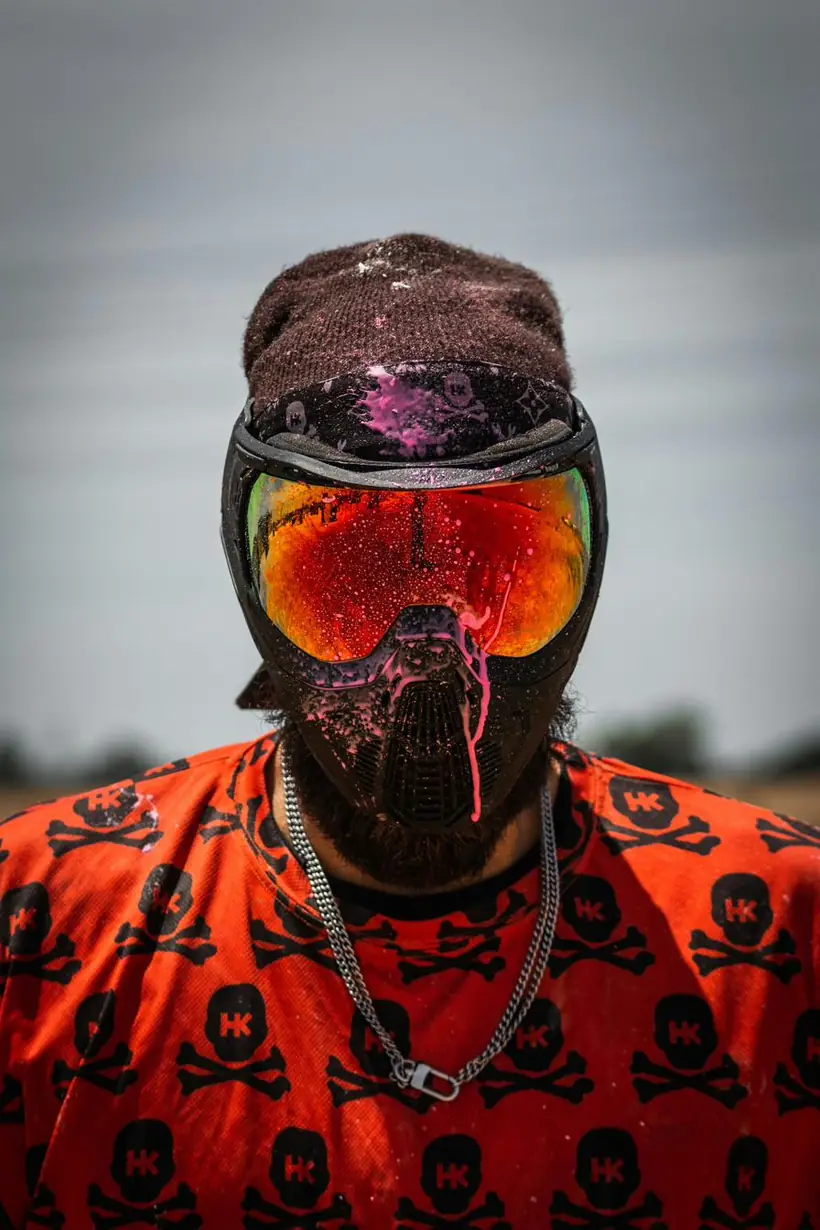 Player wearing a paint-splattered mask and mirrored goggles